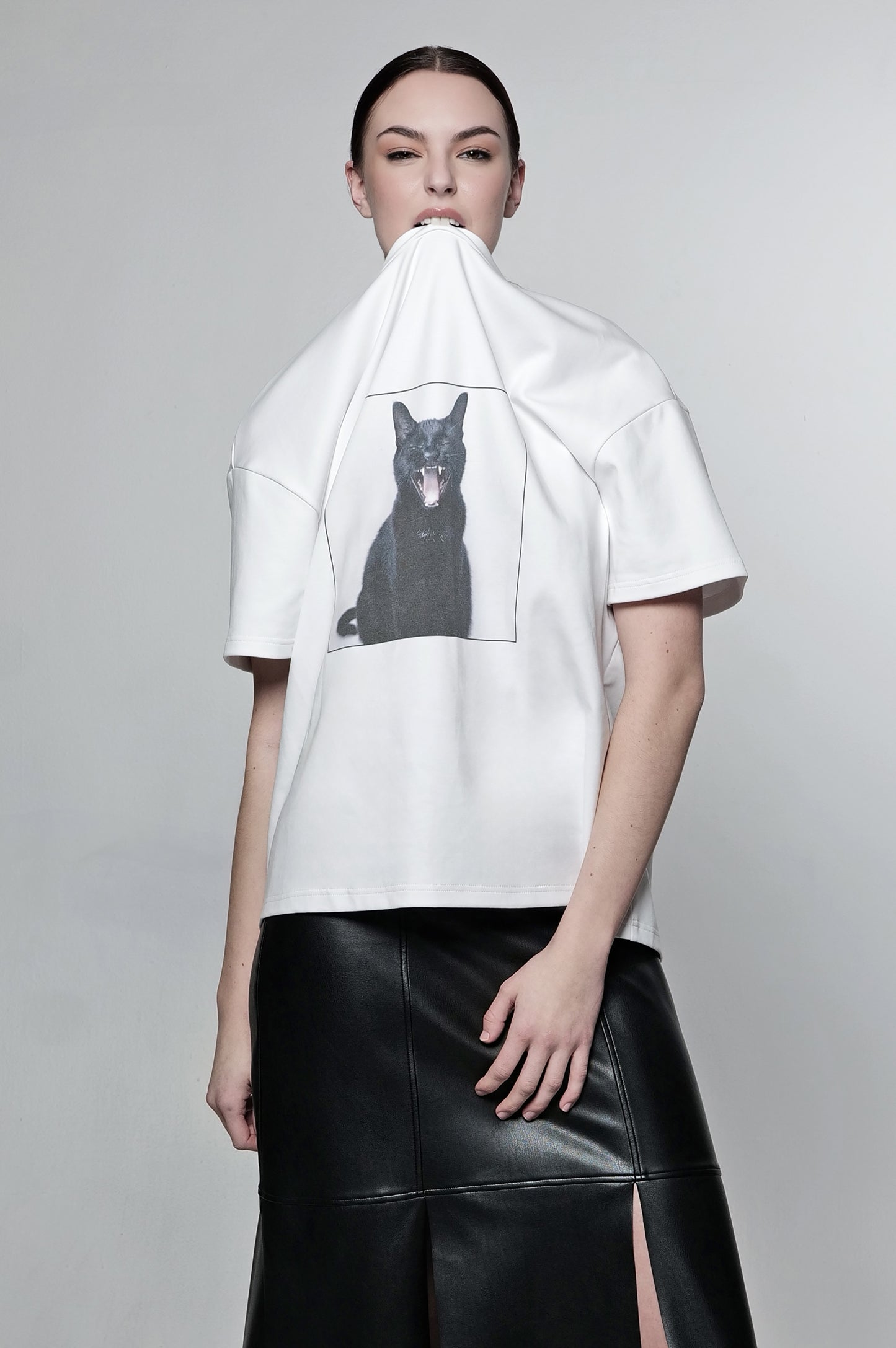 Model wearing an oversized screaming black cat graphic t-shirt