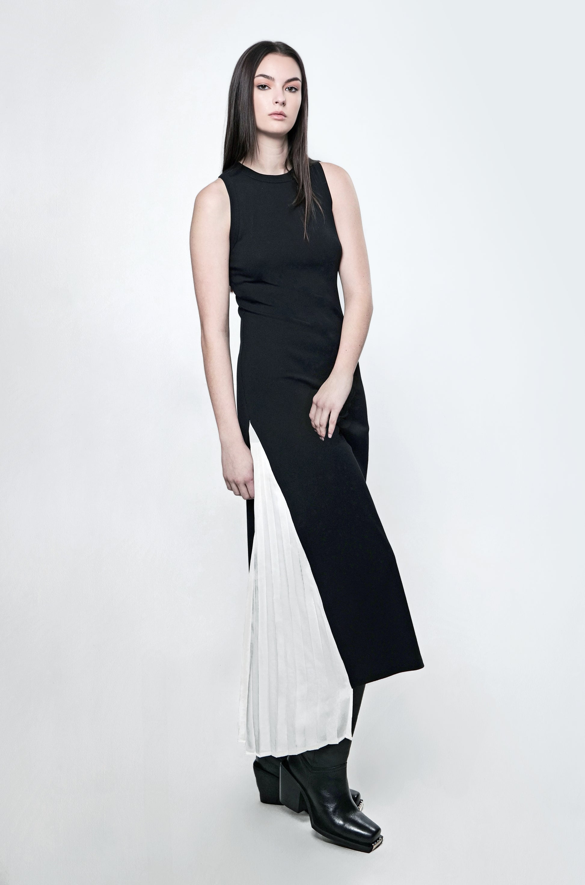 Black ribbed maxi dress with a fitted silhouette and contrast pleated panel