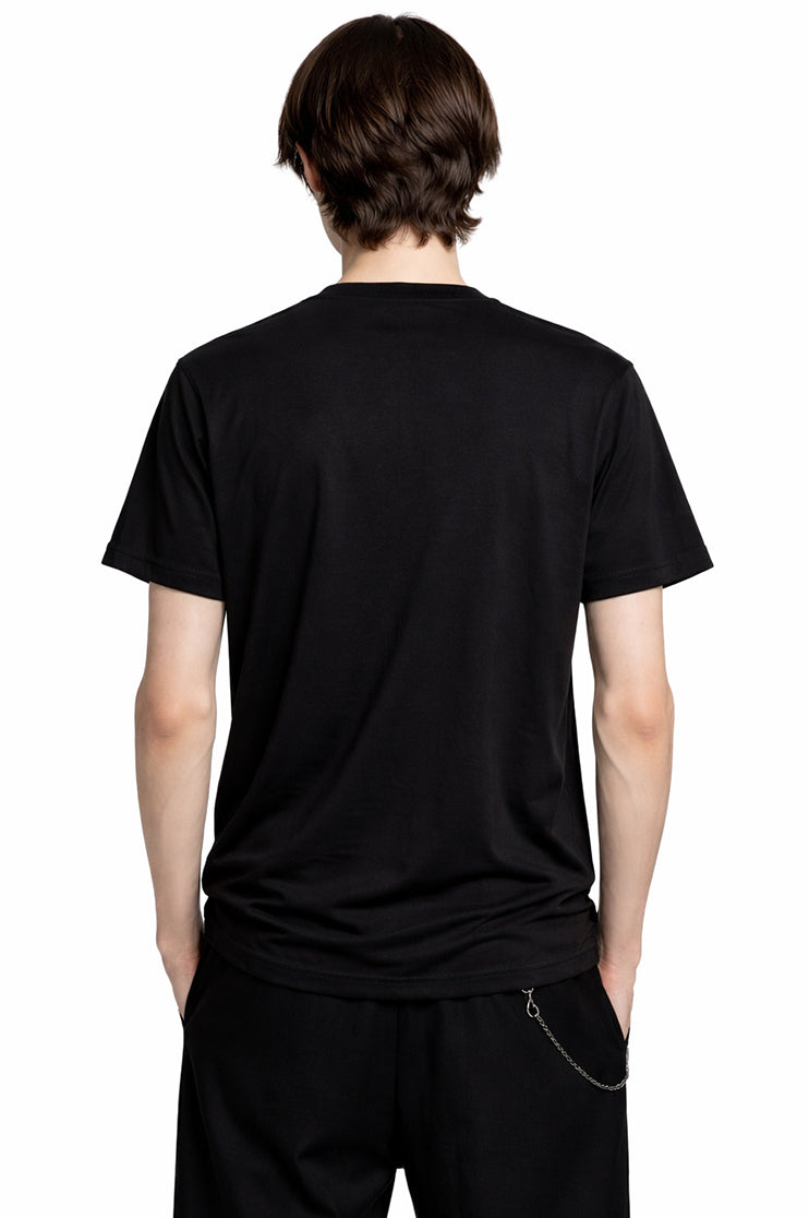 Back view of a man wearing a black t-shirt against a white background