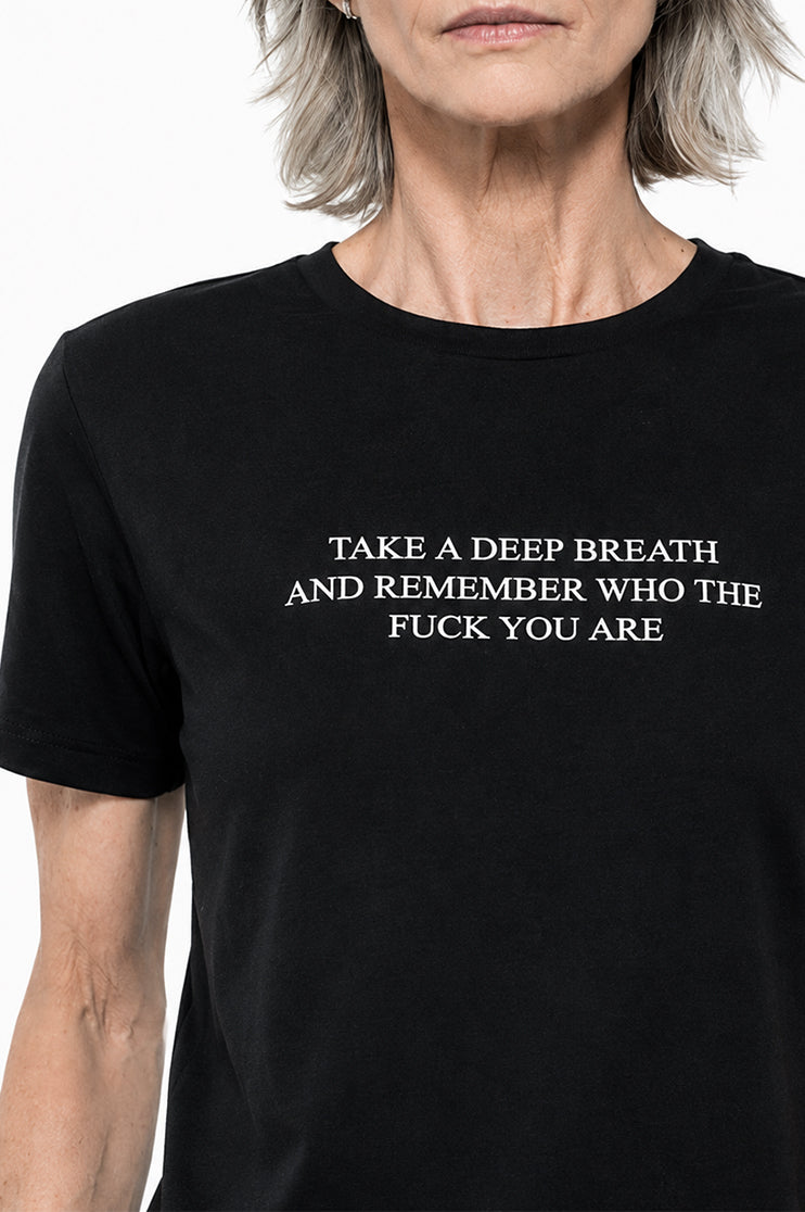 Close up of graphic t-shirt that says "take a deep breath and remember who the fuck you are"