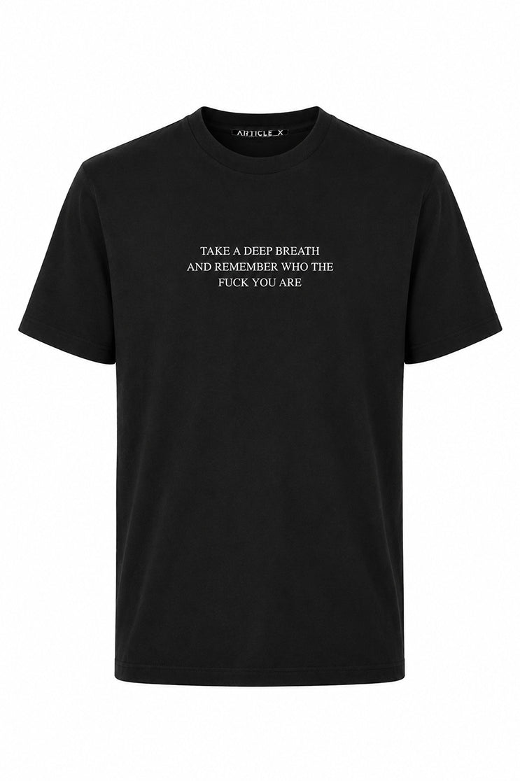 A ghost mannequin image of a black t-shirt that says "take a deep breath and remember who the fuck you are"